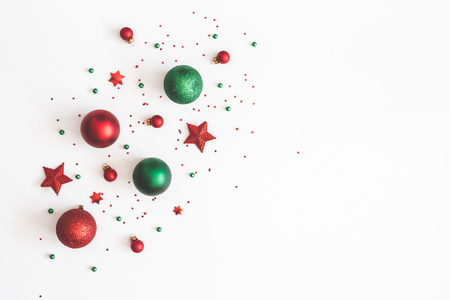 Christmas composition. Christmas red and green decorations on white background. Flat lay, top view, copy spaceの写真素材
