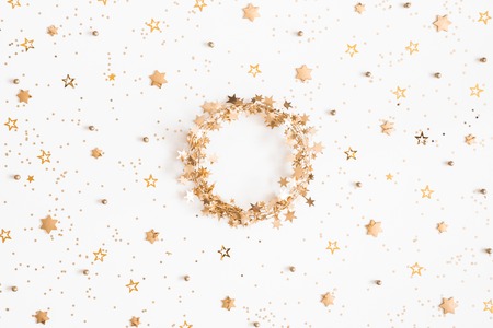 Christmas composition. Christmas wreath, golden decorations on white background. Flat lay, top view, copy spaceの写真素材
