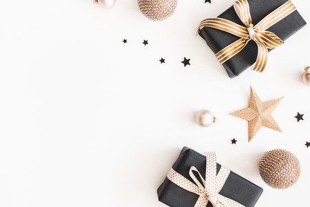Christmas composition. Gifts, black and golden decorations on white background. Christmas, winter, new year concept. Flat lay, top view, copy spaceの写真素材