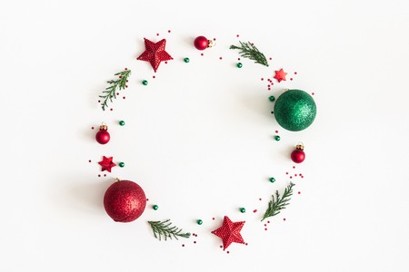 Christmas composition. Christmas wreath made of decorations, fir tree branches on white background. Flat lay, top view, copy spaceの写真素材