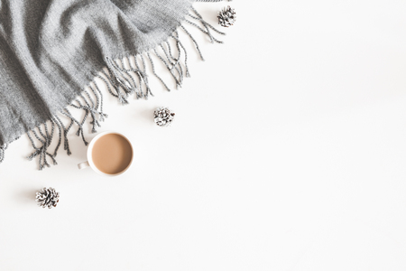 Christmas decorations, plaid, pine cones, cup of coffee on white background. Christmas, new year, winter concept. Flat lay, top view, copy spaceの写真素材