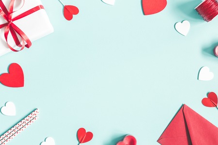 Valentine's Day background. Gifts, candle, confetti, envelope on pastel blue background. Valentines day concept. Flat lay, top view, copy spaceの写真素材