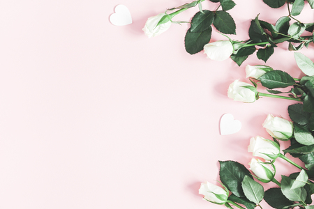 Flowers composition. White rose flowers on pastel pink background. Valentines day, mothers day, womens day concept. Flat lay, top view, copy spaceの写真素材