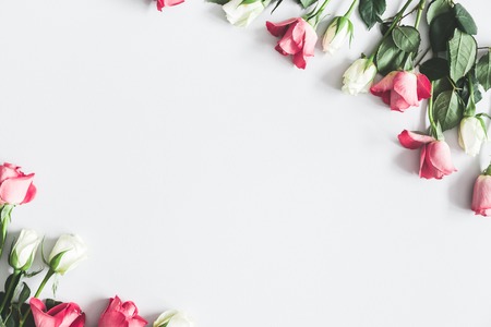 Flowers composition. Pink and white rose flowers on pastel gray background. Flat lay, top view, copy spaceの写真素材