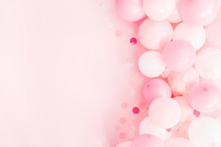 Balloons on pastel pink background. Frame made of white and pink balloons. Birthday, valentines day, holiday concept. Flat lay, top view, copy spaceの写真素材