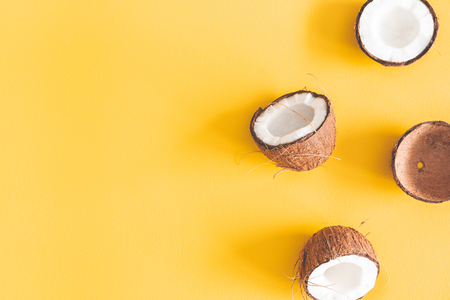 Summer composition. Coconut on yellow background. Summer concept. Flat lay, top view, copy spaceの写真素材