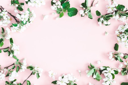 Flowers composition. Apple tree flowers on pastel pink background. Spring concept. Flat lay, top view, copy spaceの写真素材