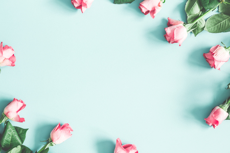 Flowers composition. Pink rose flowers on pastel mint background. Flat lay, top view, copy spaceの写真素材