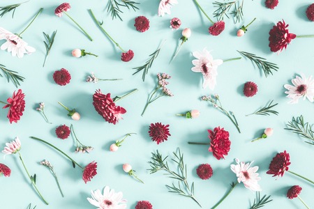 Flowers composition. Eucalyptus leaves and pink flowers on pastel blue background. Flat lay, top viewの写真素材