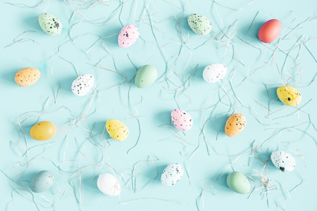 Easter eggs on pastel blue background. Spring, easter concept. Flat lay, top viewの写真素材