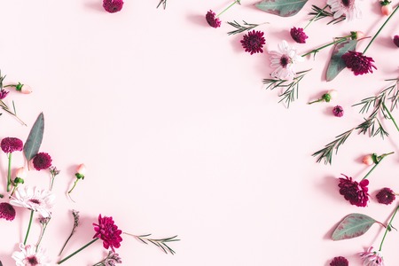 Flowers composition. Eucalyptus leaves and pink flowers on pastel pink background. Valentines day, mothers day, womens day, spring concept. Flat lay, top view, copy spaceの写真素材