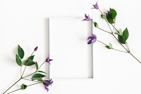 Flowers composition. Purple flowers, photo frame on white background. Spring, easter concept. Flat lay, top view, copy spaceの写真素材