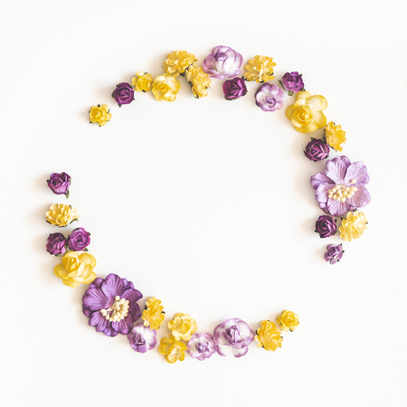 Flowers composition. Wreath made of purple and yellow flowers on white background. Flat lay, top view, copy space, squareの写真素材