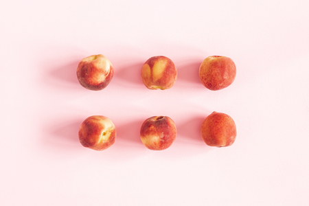 Peaches on pastel pink background. Flat lay, top viewの写真素材