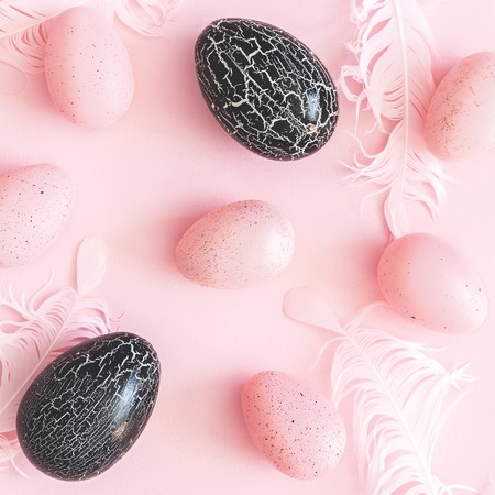 Easter composition. Pink and black easter eggs on pastel pink background. Flat lay, top view, squareの写真素材