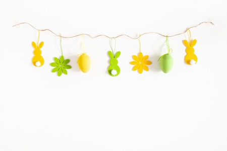 Easter composition. Easter eggs, flowers, rabbit on white background. Flat lay, top view, copy space