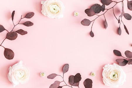 Flowers composition. Pink flowers and eucalyptus leaves on pastel pink background. Flat lay, top view, copy spaceの写真素材