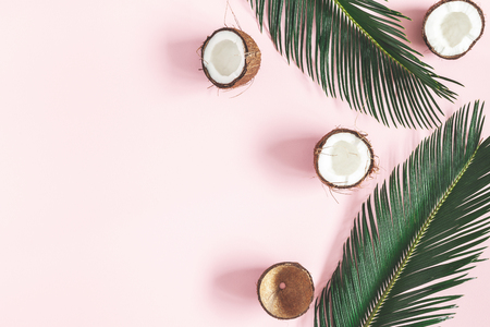 Summer composition. Coconut, palm leaf on pastel pink background. Summer concept. Flat lay, top view, copy spaceの写真素材