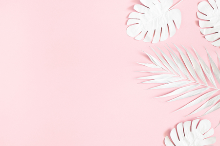 Summer composition. Tropical palm leaves on pink background. Summer concept. Flat lay, top view, copy spaceの写真素材