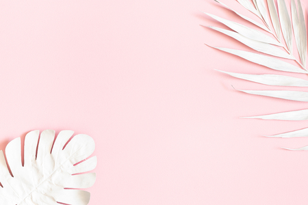 Summer composition. Tropical palm leaves on pink background. Summer concept. Flat lay, top view, copy spaceの写真素材