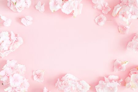 Flowers composition. Hydrangea flowers on pastel pink background. Flat lay, top view, copy space