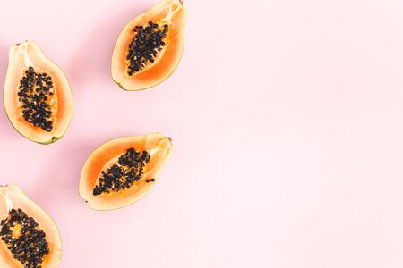 Summer fruits. Papaya on pink background. Summer concept. Flat lay, top view, copy spaceの写真素材