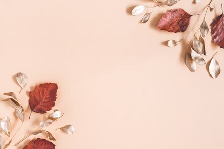 Autumn composition. Golden eucalyptus leaves on beige background. Autumn, fall concept. Flat lay,...