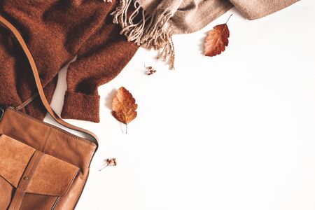 Autumn composition. Sweater, plaid, autumn leaves on white background. Flat lay, top view, copy spaceの写真素材