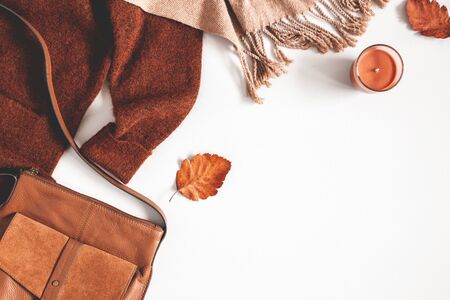 Autumn composition. Sweater, plaid, autumn leaves on white background. Flat lay, top view, copy spaceの写真素材