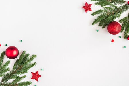 Christmas composition. Fir tree branches, red decorations on pastel gray background. Christmas, winter, new year concept. Flat lay, top view, copy spaceの写真素材