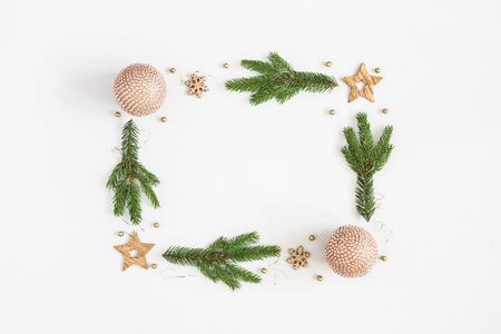 Christmas composition. Fir tree branches, golden decorations on pastel gray background. Christmas, winter, new year concept. Flat lay, top view, copy spaceの写真素材