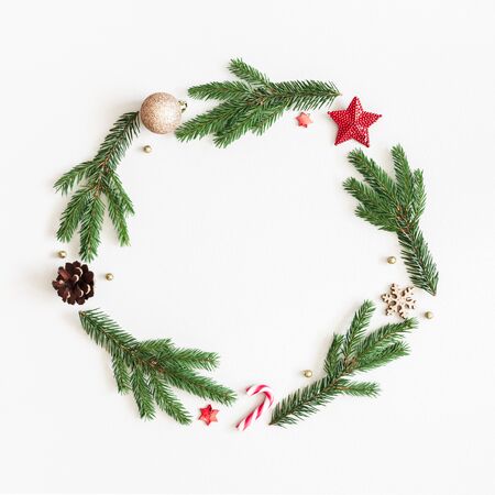 Christmas composition. Fir tree branches, red and golden decorations on pastel gray background. Christmas, winter, new year concept. Flat lay, top view, copy spaceの写真素材