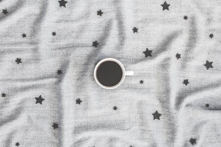 Cup of coffee, plaid, wooden toys on white background. Winter, new year concept. Flat lay, top view