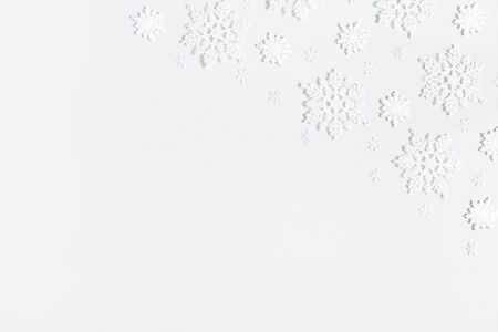Winter composition. Winter frame made of white snowflakes on pastel gray background. Winter concept. Flat lay, top view, copy spaceの写真素材
