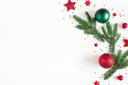 Christmas composition. Fir tree branches, red and green decorations on white background. Christmas, winter, new year concept. Flat lay, top view, copy spaceの写真素材