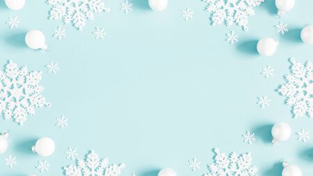 Winter composition. Pattern made of white balls and snowflakes on pastel blue background. Winter, new year concept. Flat lay, top view, copy spaceの写真素材