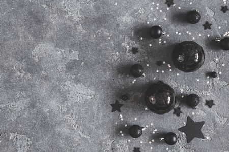 Christmas composition. Christmas black decorations on black background. Flat lay, top view, copy spaceの写真素材