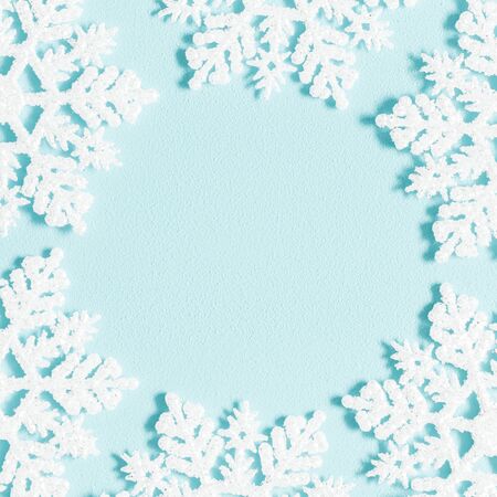 Winter composition. Wreath made of snowflakes on pastel blue background. winter, new year concept. Flat lay, top view, copy space, squareの写真素材