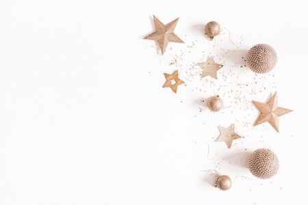 Christmas composition. Christmas golden decorations on white background. Flat lay, top view, copy spaceの写真素材