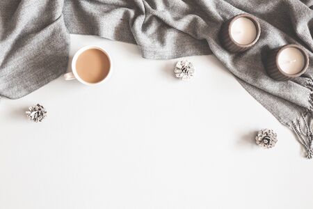 Christmas composition. Cup of coffee, scarf on gray background. Christmas, winter concept. Flat lay,...