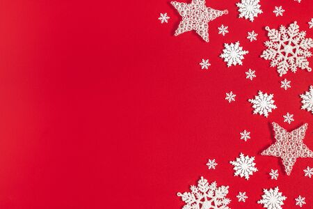 Christmas or winter composition. Pattern made of snowflakes on red background. Christmas, winter, new year concept. Flat lay, top view, copy spaceの写真素材