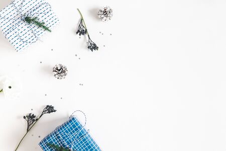 Christmas composition. Gift box, fir tree branches, decorations on white background. Christmas, winter, new year concept. Flat lay, top view, copy spaceの写真素材