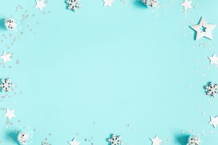 Christmas composition. Silver decorations on pastel blue background. Christmas, winter, new year concept. Flat lay, top view, copy spaceの写真素材
