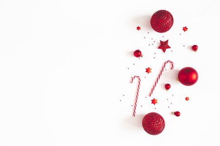Christmas composition. Red decorations on white background. Christmas, winter, new year concept. Flat lay, top view, copy spaceの写真素材