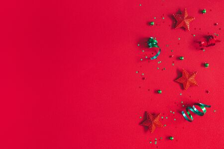 Christmas composition. Pattern made of christmas decorations on red background. Flat lay, top view, copy spaceの写真素材