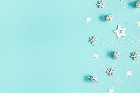 Christmas composition. Silver decorations on pastel blue background. Christmas, winter, new year concept. Flat lay, top view, copy spaceの写真素材
