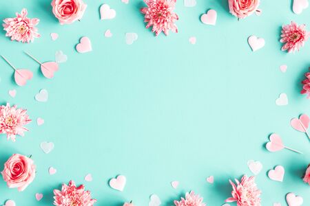 Valentine's Day background. Pink flowers, hearts on pastel blue background. Valentines day concept. Flat lay, top view, copy spaceの写真素材