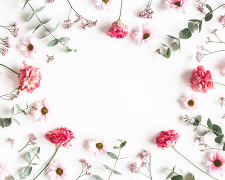 Flowers composition. Frame made of pink flowers and eucalyptus branches on white background. Valentines day, mothers day, womens day concept. Flat lay, top viewの写真素材