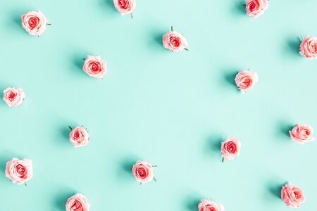 Flowers composition. Rose flowers on blue background. Flat lay, top view, copy space