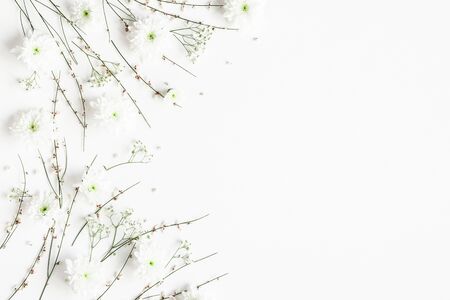 Flowers composition. White flowers on white background. Spring concept. Flat lay, top view, copy spaceの写真素材